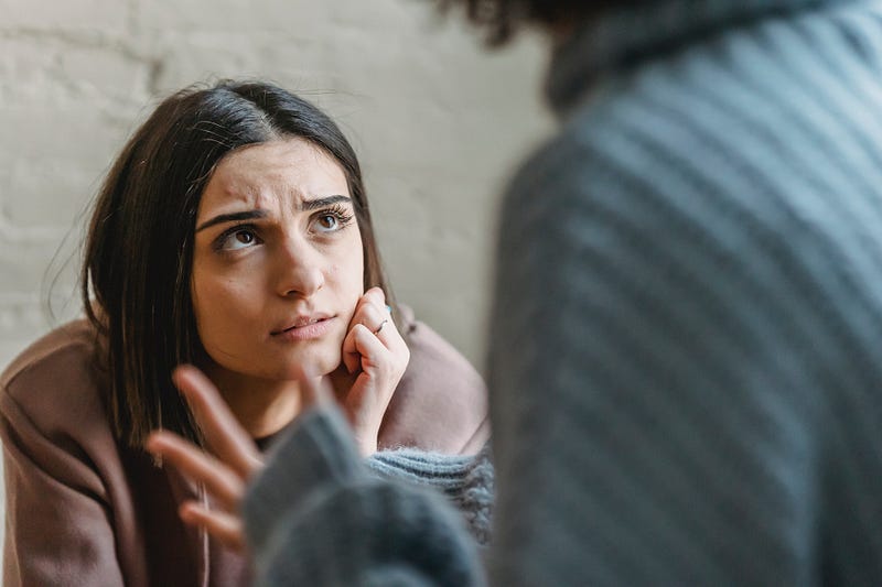 A woman reflecting on her feelings during a conflict.