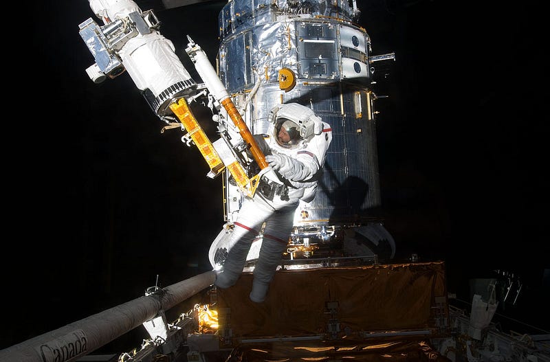 Astronaut performing a spacewalk, showcasing the risks involved