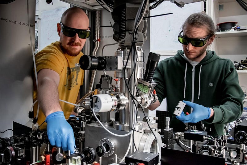 Scientists working on cooling nanoparticle experiments.