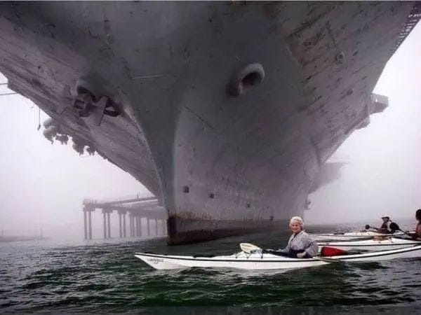 Boat size comparison with a giant ship